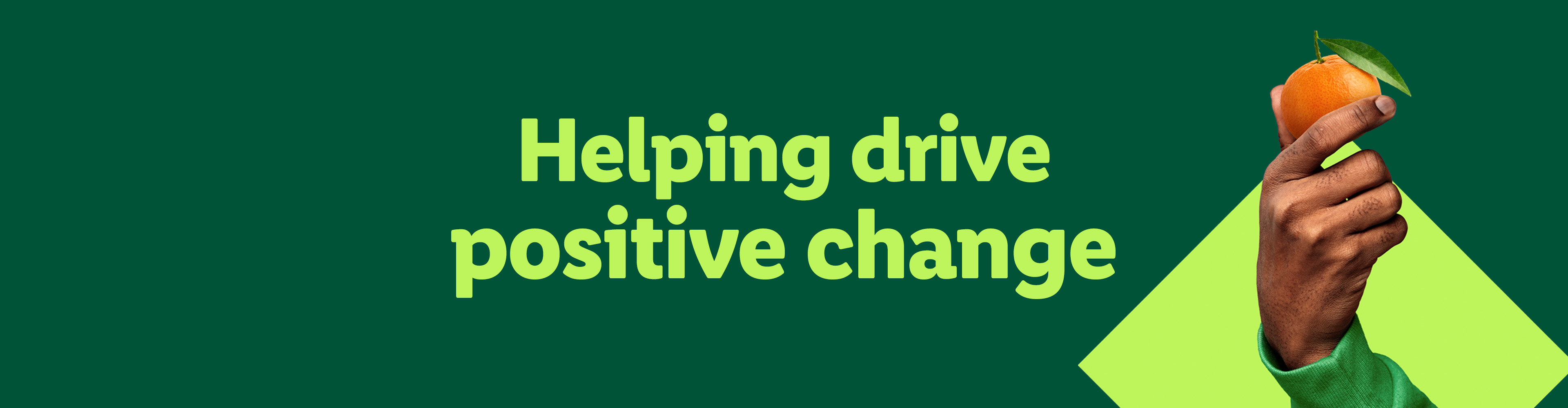 A hand holding an orange with the text 'Helping drive positive change'.