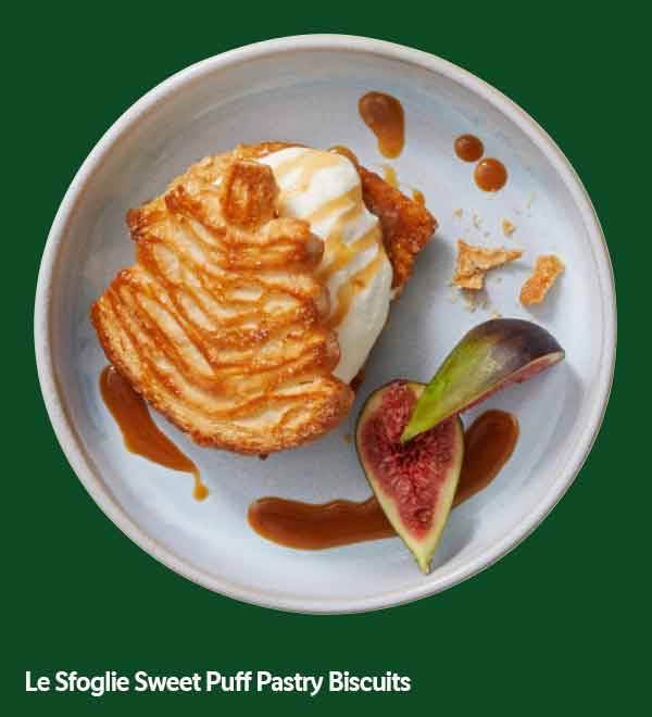 Sweet puff pastry biscuits with ice cream, caramel, and figs on a white plate.