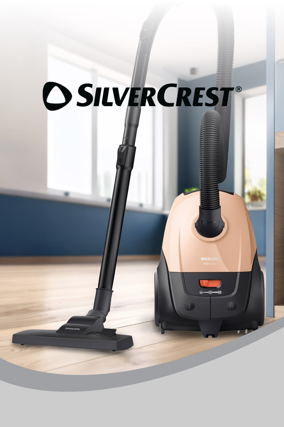 Vacuum cleaner with hose and nozzle on a wooden floor, with a light background.