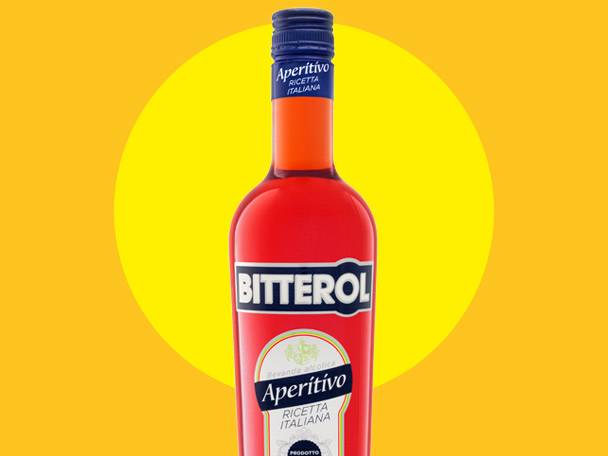 Red aperitif bottle with a blue cap and white labels, set against a yellow and orange background.