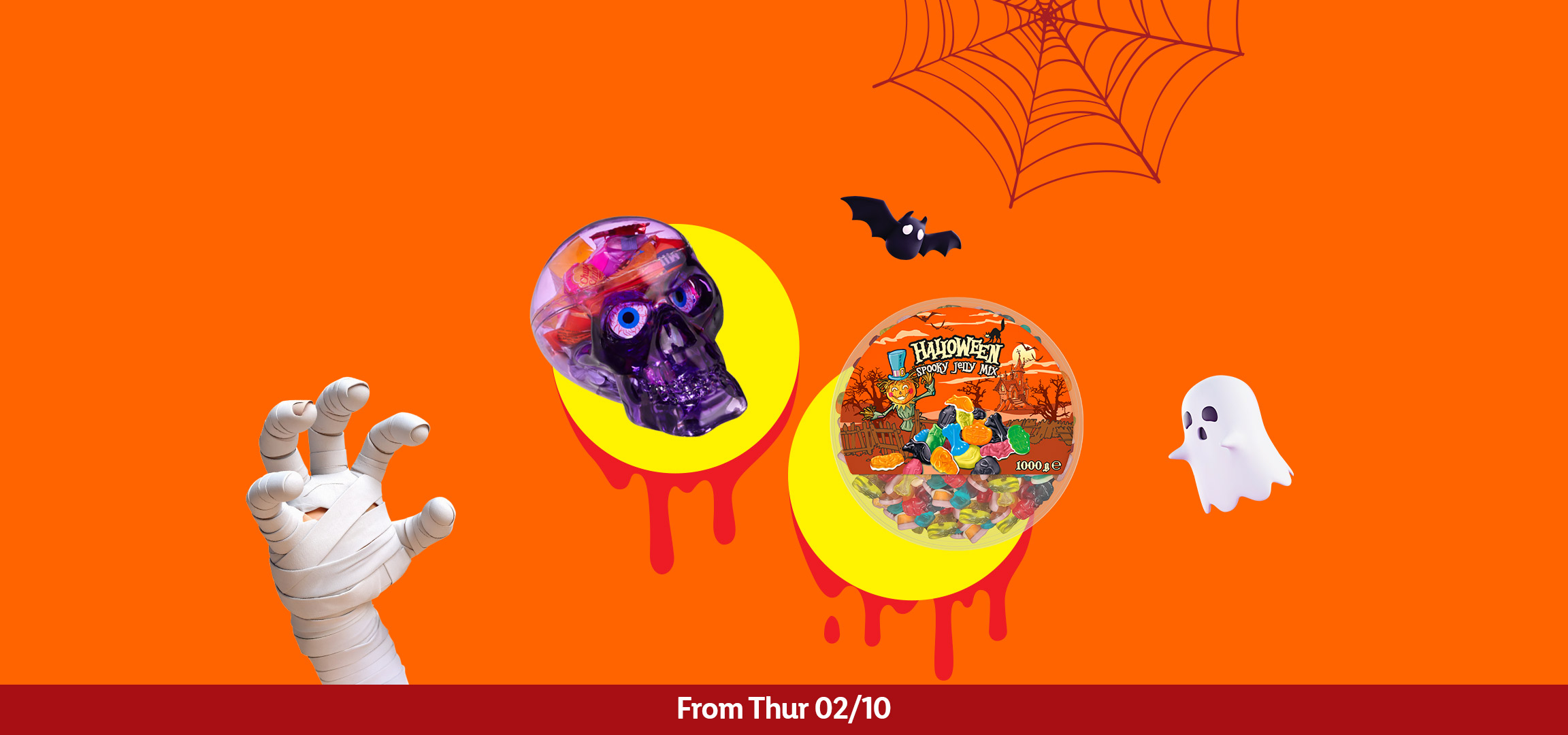 Halloween-themed candies in a skull container and a tub, with spooky decorations.