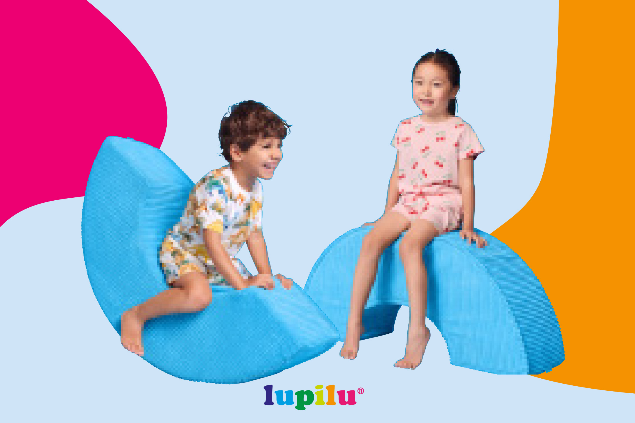 Two children playing on blue soft play shapes, smiling, against a colorful background.