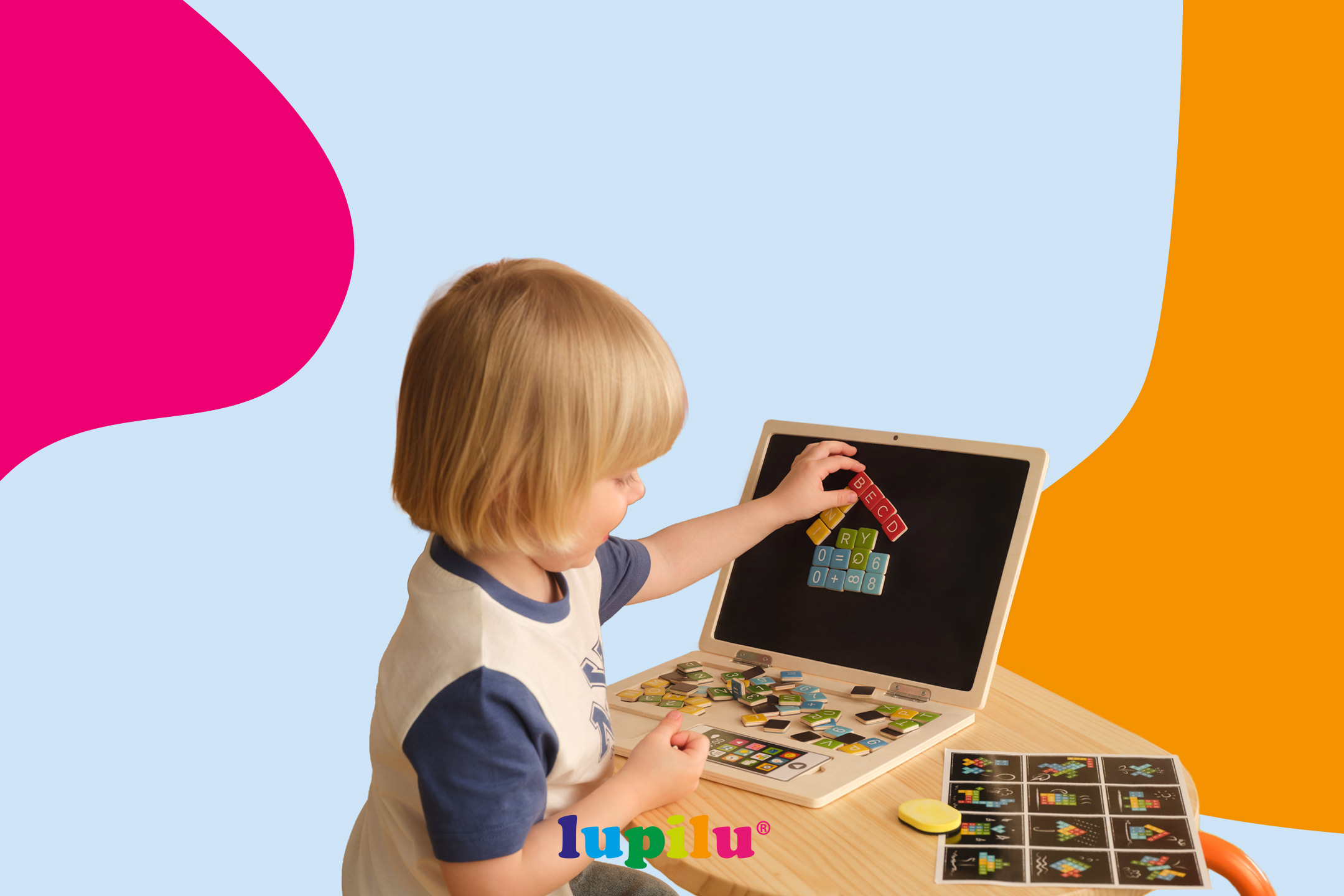 Child playing with a wooden laptop toy, arranging colorful magnetic letters and numbers on the screen.