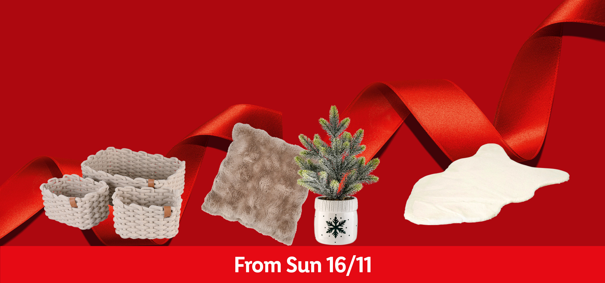 Christmas decor: woven baskets, faux fur rug, small Christmas tree, and a fluffy cushion.