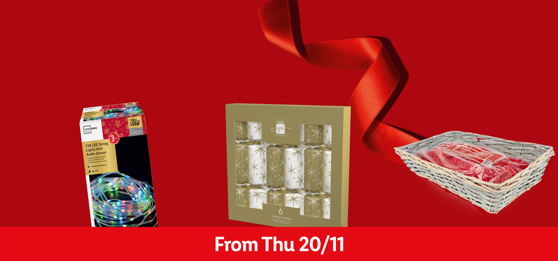 Christmas decorations: LED string lights, snowman candle, crackers, and a gift basket.