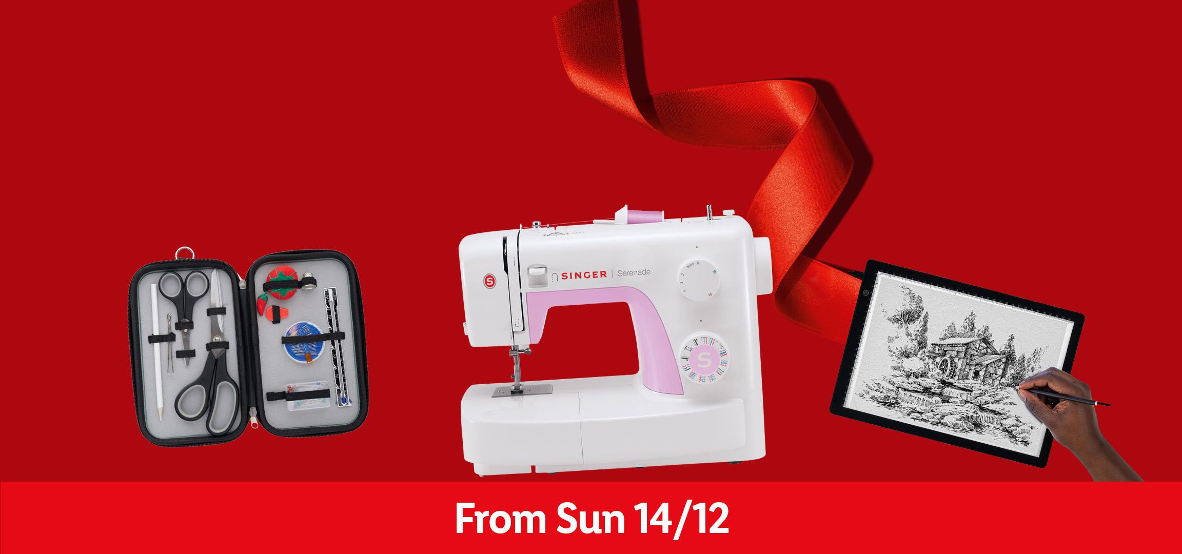 Singer sewing machine, sewing kit, and light pad for drawing on a red background.