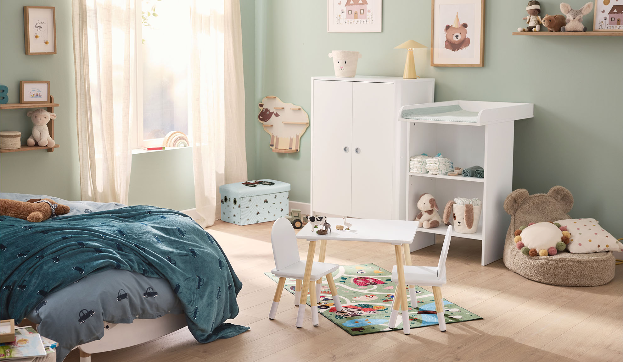 Children's room with a bed, changing table, wardrobe, and play table with chairs.