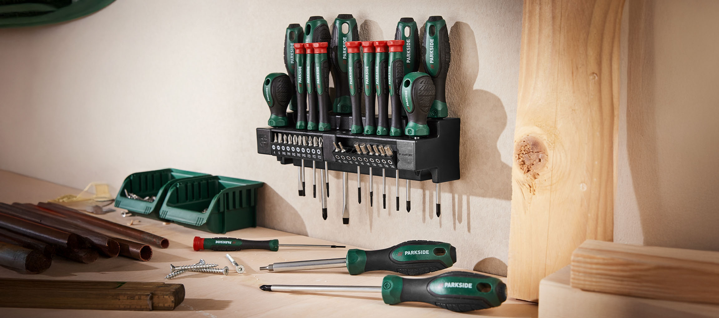 PARKSIDE screwdriver set with various bits and tools on a workbench.