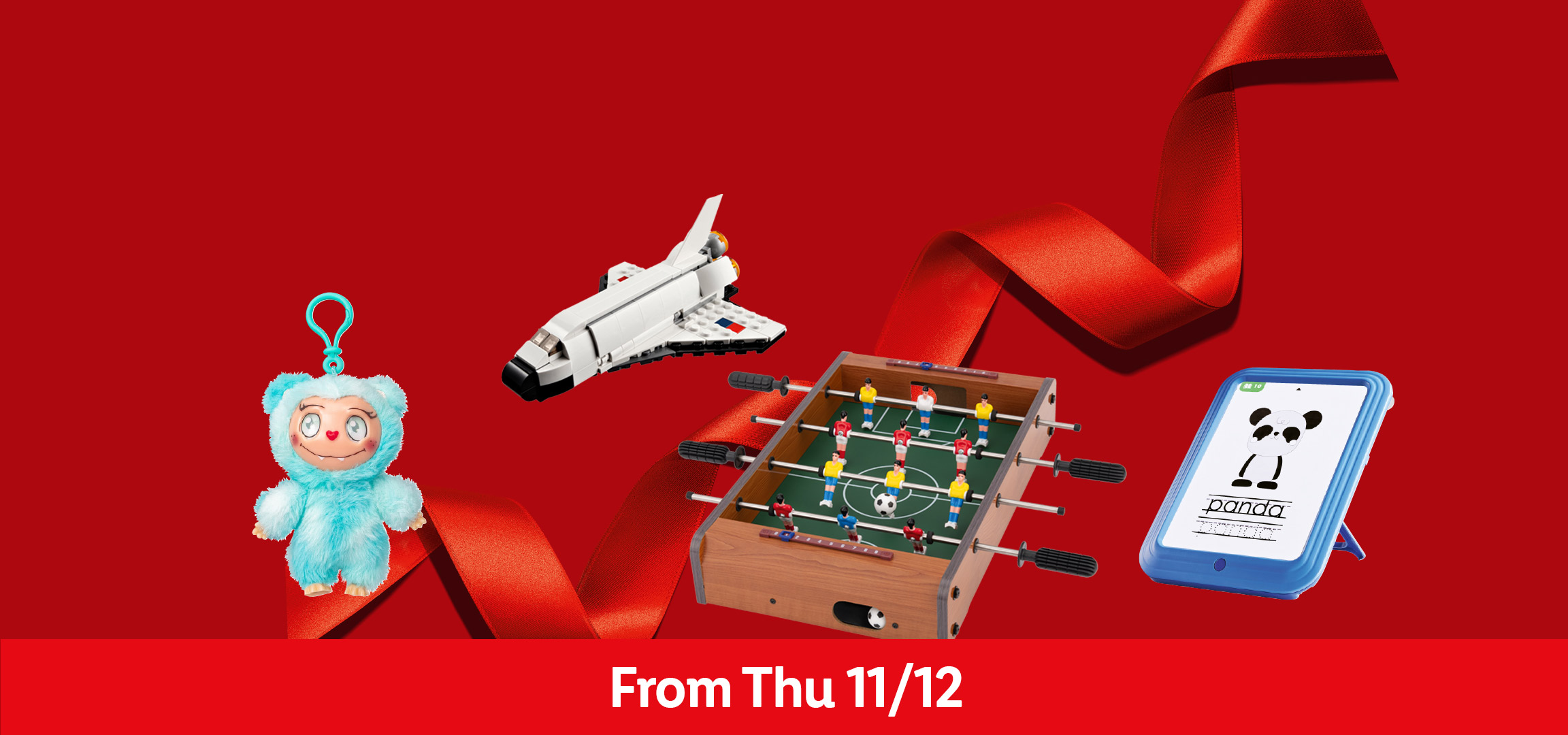 Plush toy, LEGO space shuttle, foosball table, and a tablet on a red background.